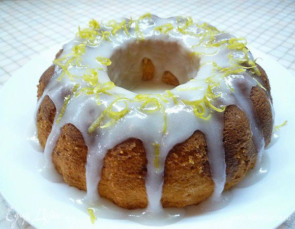 Остывший кекс покрываем глазурью и посыпаем цедрой лимона. Для глазури в глубокую тарелку насыпаем 50 г сахарной пудры и постепенно, по чайной ложке добавляем лимонный сок. Добавляем и перемешиваем. Как только вся пудра намокнет, а масса будет еще густой — глазурь готова.