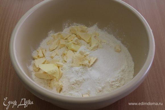 К муке с разрыхлителем добавить сахар, соль, порубленное на кусочки масло.