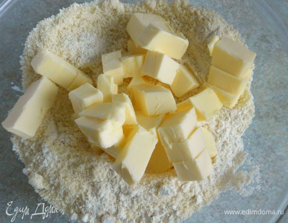 В миску просеять муку, добавить миндаль и холодное, порезанное кусочками масло.