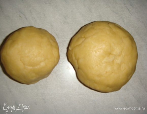 Для начала приготовим тесто: в миску просеять муку, всыпать сахар, разрыхлитель, добавить яичные желтки и кусочки холодного сливочного масла. Замесить тесто и разделить его на две части — большую и меньшую. Меньшую часть убрать в морозилку.