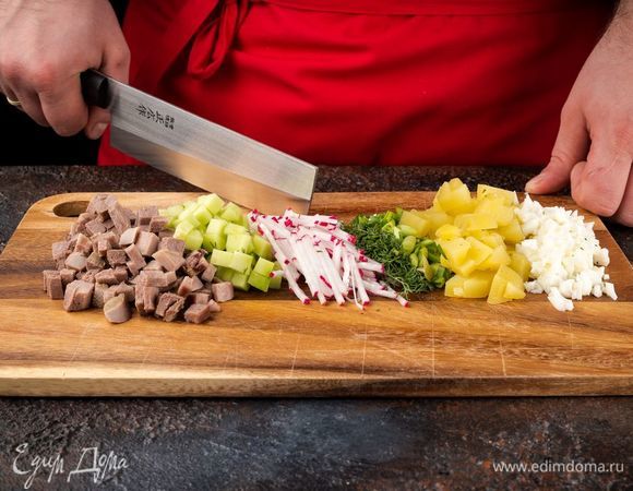 Отварите картофель, язык, яйца. Нарежьте кубиками картофель, огурцы, редис, яичные белки. Укроп и зеленый лук порубите.
