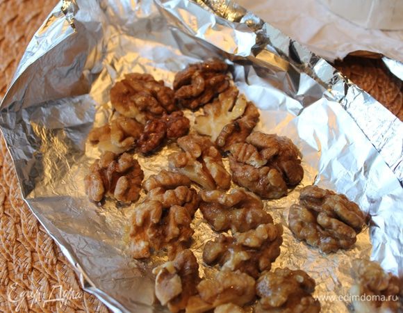На фольге разложите смазанные медом орехи, перенесите их на гриль. Зарумяненные с одной стороны орехи переверните и запеките с другой стороны. 