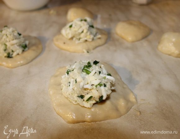 Тесто разделите на порции, пальчиками сформируйте лепешку и положите добрую ложку начинки. Края тщательно слепите и положите на противень пирожок швом вниз.
