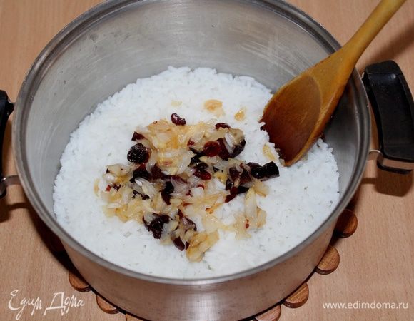 Переложите лук к рису, перемешайте, готовьте на медленном огне 5 минут.