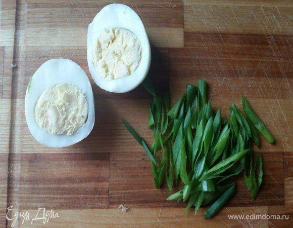 Все готово. Пришло время собирать суп. Яйца разрежем пополам, зеленый лук по косой.