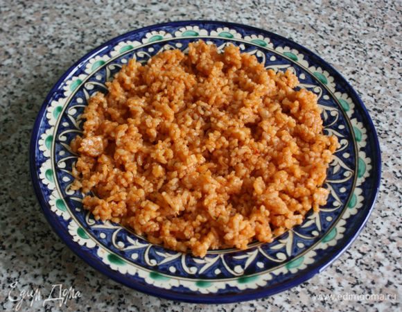 Сервировать рис на большое блюдо или сразу на порционные тарелки.