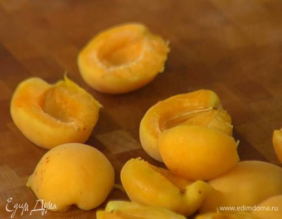 Абрикосы разделить пополам и удалить косточки.