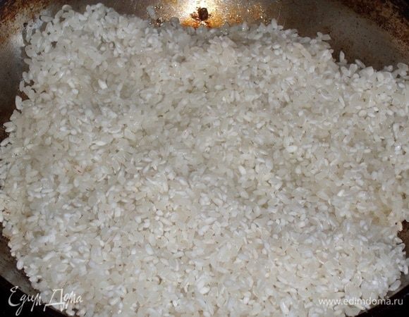В раскаленную сковороду наливаем 2 ст. л. растительного масла. Высыпаем промытый рис ТМ «Националь».