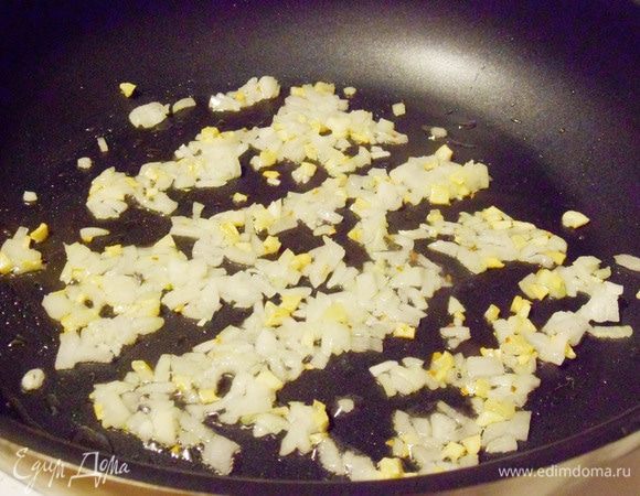 Почти сразу же добавить мелко нарезанный лук. Обжаривать на среднем огне до полупрозрачного состояния лука.