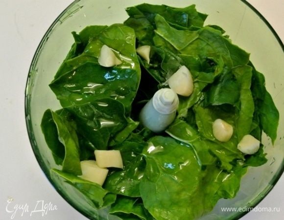 В блендер выложить промытый и обсушенный шпинат, чеснок, 1 чайную ложку растительного масла, 2-3 столовые ложки воды. Если пюре получилось очень густым, добавить воду.