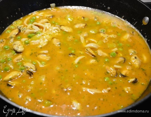 Влить куриный бульон и белое вино.