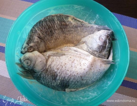 Карасей обмажем сметаной, посолим и поперчим по вкусу. Оставим на часок мариноваться.