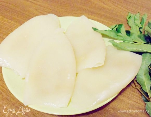 Очищенные замороженные тушки кальмаров разморозить на самой холодной полке в холодильнике. Промыть проточной водой. 