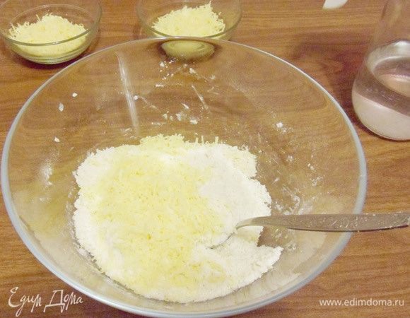 Хорошо перетереть муку с маслом и добавить одну треть натертого сыра. Перемешать.