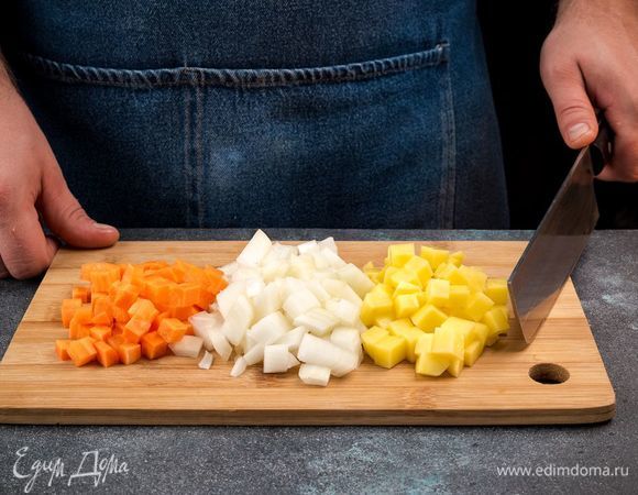 Очистите и нарежьте картофель. Репчатый лук измельчите, а морковь нарежьте кубиками.