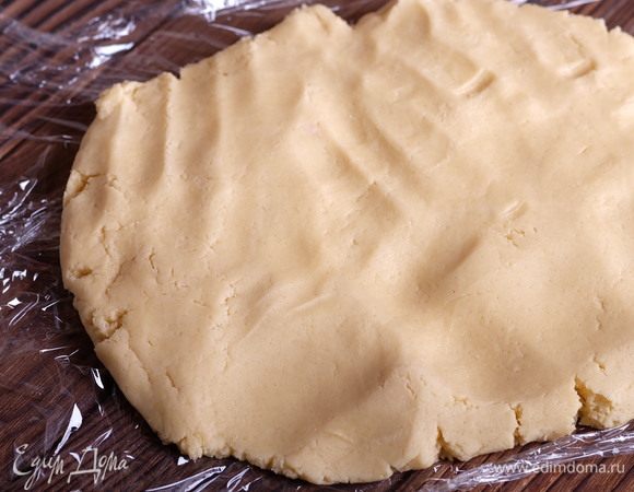 Из образовавшегося комка теста формируем руками шар, выкладываем его на пищевую пленку и делаем из него брусок толщиной 2-2,5 см.
