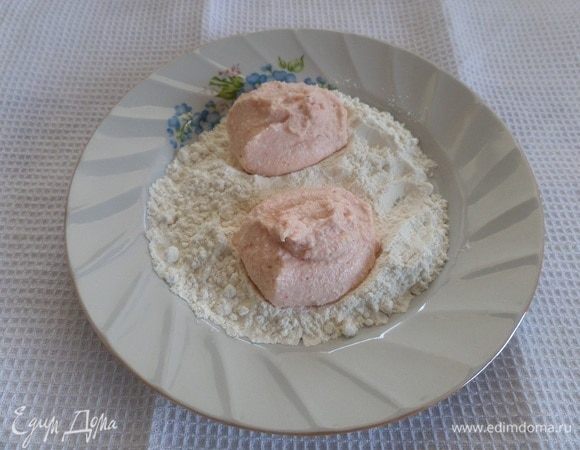 В тарелку насыпаем 1 ст. л. муки и равномерно распределяем по тарелке. Ложкой выкладываем приготовленный фарш. Обваливаем в муке порции фарша. Придаем форму котлет.
