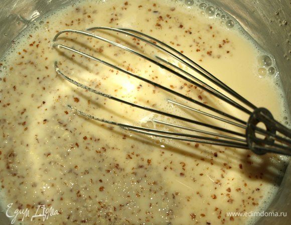 Добавляем половину молока и миндальную крошку к яйцам и взбиваем до однородной массы.