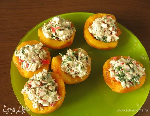 На персики выкладываем салат. Существует множество блюд с крабовыми палочками, но так уж повелось, что одни из любимых рецептов — различные салаты, в них крабовые палочки не подвергаются тепловой обработке, сочные, да и сочетаний продуктов в салатах, салатах-коктейлях, салатах-намазках множество, т.ч. стол не будет однообразным.