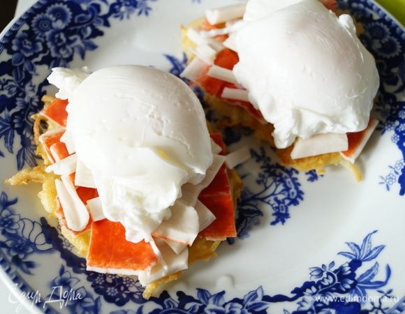 На готовые картофельные «блинчики» выложить порезанные крабовые палочки (количество по желанию, у меня ушло по 1 шт. на порцию). Поверх поместить подготовленные яйца-пашот.