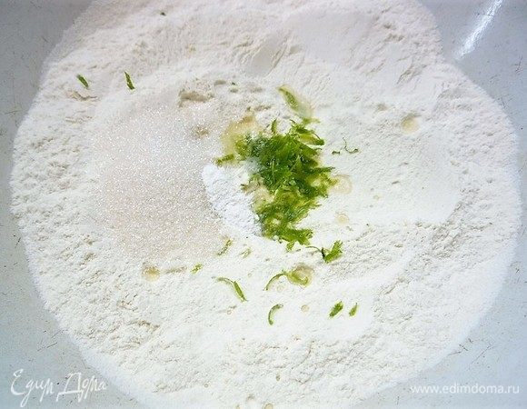 Приготовим тесто: в чашку просеиваем муку, добавляем щепотку соли, сахар, разрыхлитель, перемешиваем, добавляем сок и цедру лайма, еще раз перемешиваем.