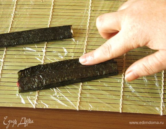 Каждую палочку оборачиваем в лист нори. Палочки VICI чуть длиннее, ширину нори подгоняем под палочку. Обычно кадзари-суши  готовятся из половинки листа нори, но обрезать палочки не будем, так получится больше начинки! Край нори смачиваем слегка водой, тогда соединение листов будет прочным.
