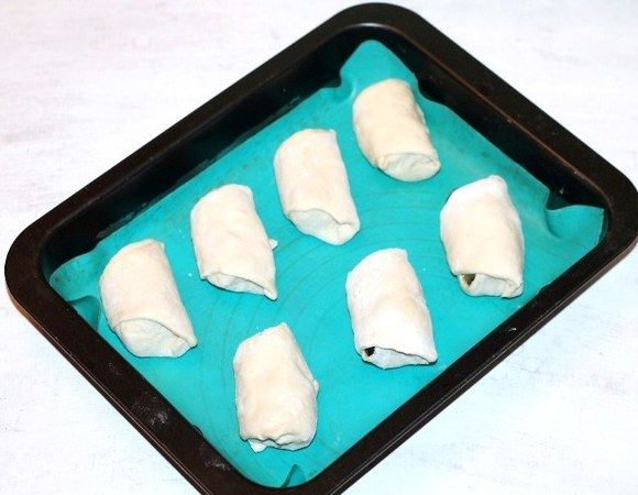 Выкладываем заготовки на противень, заранее застеленный силиконовым ковриком. Ставим противень в духовку и включаем минимальную температуру от 40–100°C. Оставляем пирожки на расстойке минут на 20 до увеличения в 2 раза.