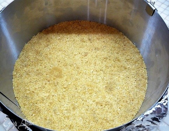 Выкладываем основу из печенья ровным слоем в разъемную форму (диаметром 22 см). Выравниваем и слегка придавливаем поверхность. Убираем в холодильник.