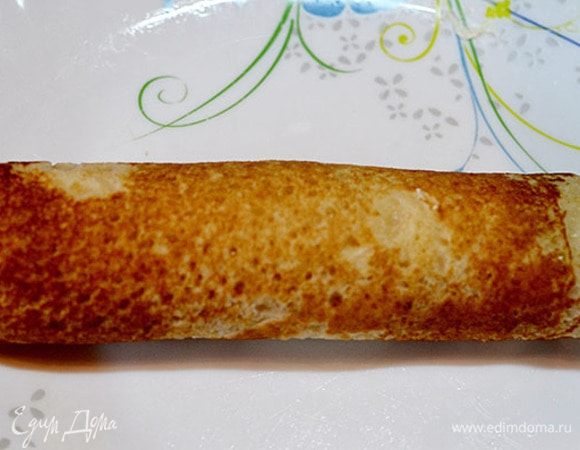 Сворачиваем туго рулетом. Затем нарезаем. Сверху кладем по ломтику семги.