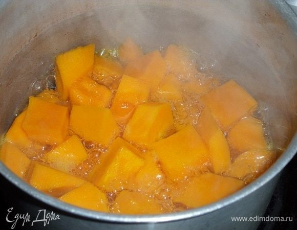 Кастрюлю ставим на огонь. Кусочки тыквы выкладываем в кастрюлю. Добавляем 100 мл воды. Варим 10-12 минут после закипания.