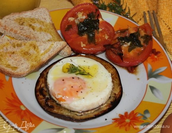 По готовности яйца до той твердости, которая вам по душе, аккуратно его отделяем ножом от формы. Убираем форму, сервируем на блюдо яичницу-глазунью на баклажане, сбрызнем маслом, посыпаем свежемолотым перцем. 