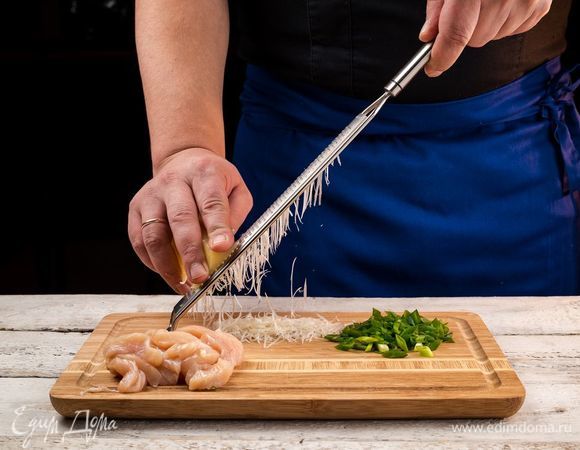 Нарежьте зеленый лук, промойте и высушите шпинат. Куриное филе нарежьте тонкими полосками. Сыр натрите на терке.
