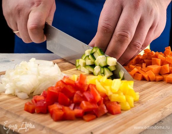 Лук нарежьте полукольцами, цукини нарежьте кубиками, морковь и болгарский перец. 