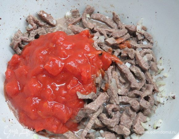 Добавляем к мясу томатный соус. Если соус густой, можно разбивать его горячей водой, соус нужен консистенции жидкой сметаны. 