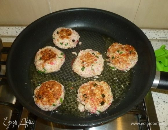 В сковороде разогреть масло. Руки смочить водой, мокрыми руками скатать шарик и немного сплющить его, придав форму шайбочки. Выкладывать котлетки на сковороду. Обжаривать с двух сторон до золотистой корочки.