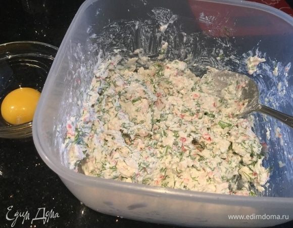 Смешайте творог, чеснок выдавленный прессом, крабовые палочки и укроп. Отделите желток от белка, желток оставьте для смазывания, а белок добавьте в начинку и перемешайте.