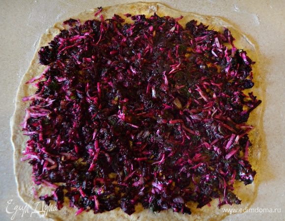 Сверху равномерно распределите подготовленную начинку, оставляя свободным место по 1,5 см от краев.