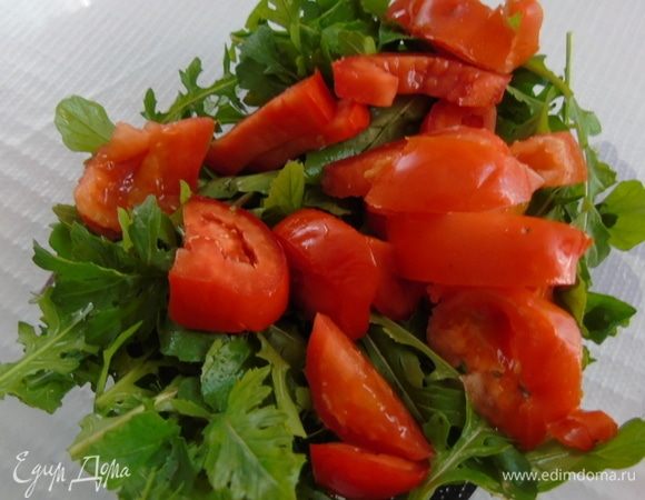 Помидоры нарежьте и отправьте к руколе.