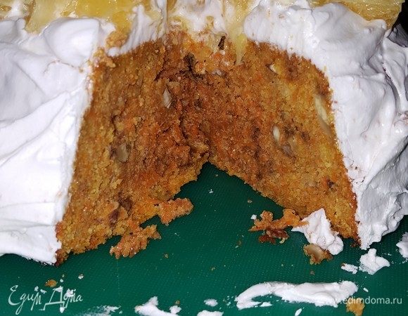 Делаем глазурь. Взбиваем белок от одного яйца с щепоткой соли на большой скорости, примерно 1 минуту. Добавляем просеянную сахарную пудру, лимонную кислоту и ванильный сахар. Взбиваем смесь до пышности. Намазываем пирог глазурью и украшаем нарезанным мелкими кубиками апельсином (с которого мы сняли цедру).