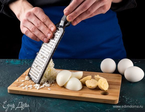Отварите яйца, отделите белки от желтков, измельчите желтки до состояния мелкой крошки. Натрите на средней терке яичные белки.