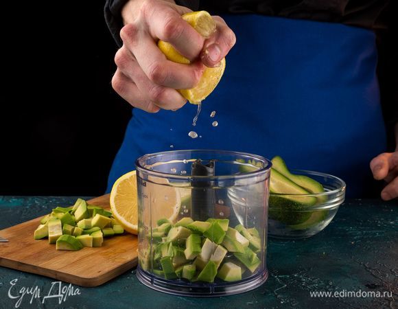Порубите авокадо кубиками, выложите в блендер и сбрызните лимонным соком. Измельчите авокадо в блендере.
