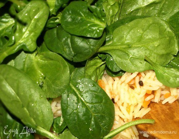 Шпинат промыть, дать стечь воде. Кладем сверху на рис шпинат. Перемешивать не надо. Томим 2 минуты.