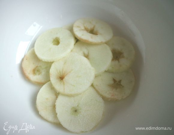 Яблоки почистить, нарезать кружочками, серединку с семенной частью удалить острым ножом. Чтобы кружочки из яблок были одинакового размера, выровняйте их, воспользовавшись для этого рюмкой или небольшим стаканчиком. Сбрызнуть яблоки лимонным соком, чтобы они не потемнели.