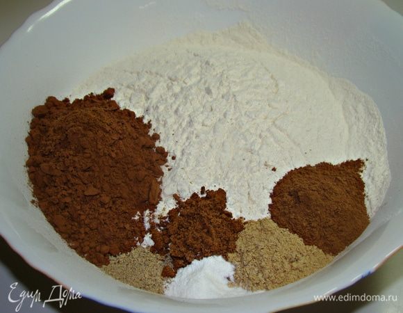 Пока масса остывает, в миску просеять муку и добавить какао и специи. 