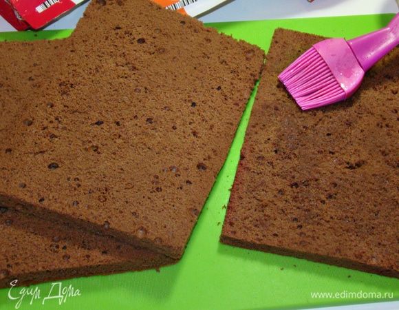 Тем временем займемся бисквитом. Для этого разделить желтки и белки. Взбить белки с сахаром в крепкую пену. По одному добавить желтки. Затем всыпать муку с какао и аккуратно перемешать лопаткой. Дно формы застелить пекарской бумагой, вылить тесто и выпекать в разогретой до 170–180°С духовке минут 30. Готовый бисквит перевернуть, снять форму и полностью остудить. Затем разрезать на коржи и пропитать сиропом. 