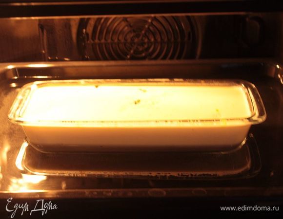 Разогрейте духовку либо до 160°С без конвекции (либо до 140°С с конвекцией). Форму для выпечки поместите в другую форму, большего размера, заполненную водой — так, чтобы вода доходила до середины формы с рисом.