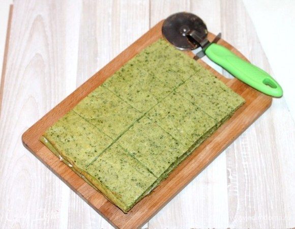 Вторую часть коржа, кладем на сыр Hochland и разрезаем на части. 