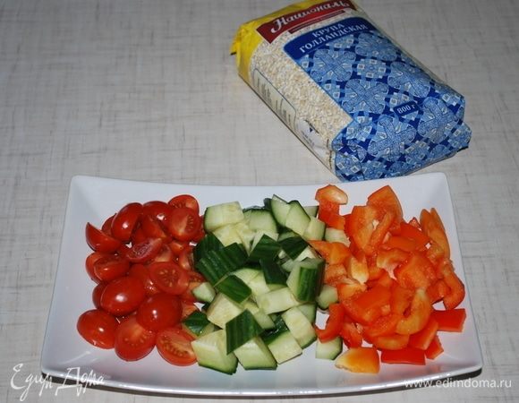Помидоры черри разрезать на две части, огурец и болгарский перец порезать кубиками.