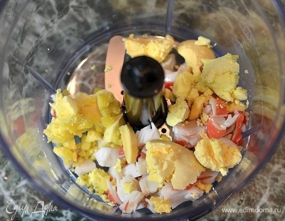 В чашу блендера кладем нарезанное вареное яйцо и нарезанные крабовые палочки.