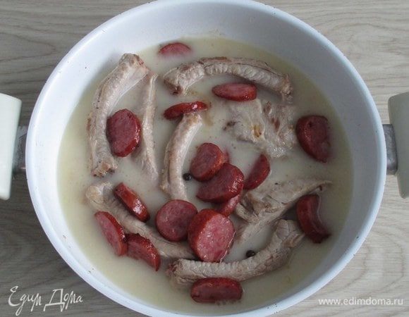 Соедините соус с ребрами и колбаской. Мне нравятся два варианта: либо в глубокой сковороде, в которой готовился соус, либо в чаше мультиварки.